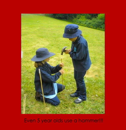 Young students use a hammer